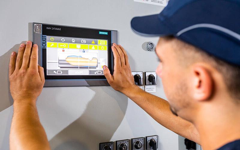 Mitie engineer using a touch screen interface